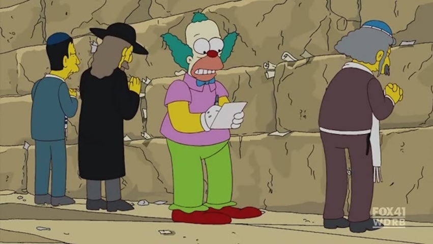 Krusty writing a note at the Kotel